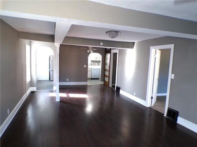 Unfurnished room featuring dark hardwood / wood-style floors and ceiling fan | Image 2