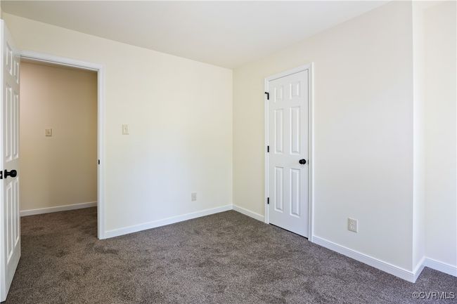 Empty room with dark colored carpet and baseboards | Image 21