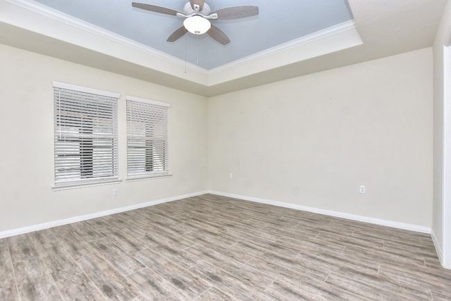 Primary Bedroom has tray ceiling and ceiling fan already in place. | Image 18