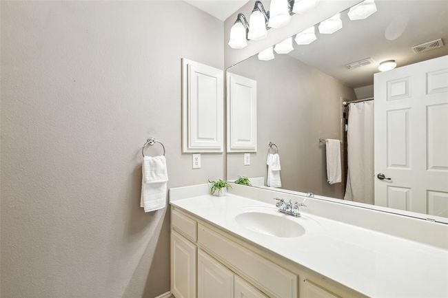 Bathroom featuring vanity with extensive cabinet space | Image 24