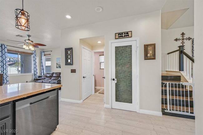 Kitchen featuring visible vents, baseboards, ceiling fan, light wood-style floors, and stainless steel dishwasher | Image 13