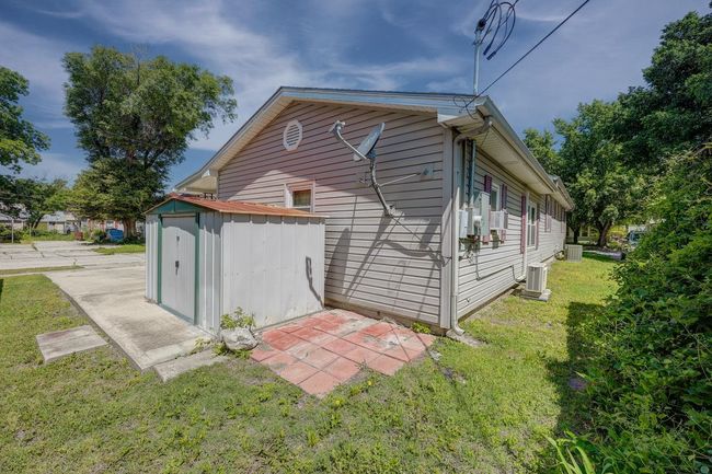View of property exterior with a yard and central AC unit | Image 20