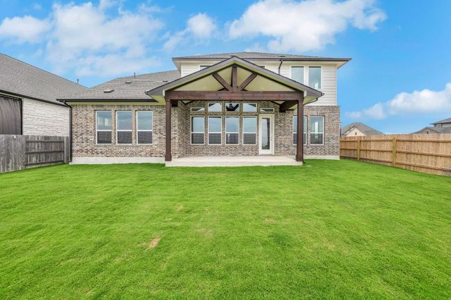 Rear view of property with a patio, brick siding, and a fenced backyard | Image 25