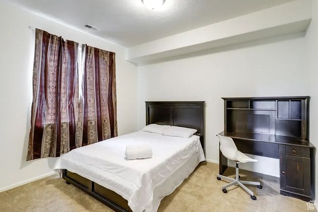 Carpeted bedroom featuring baseboards and visible vents | Image 22