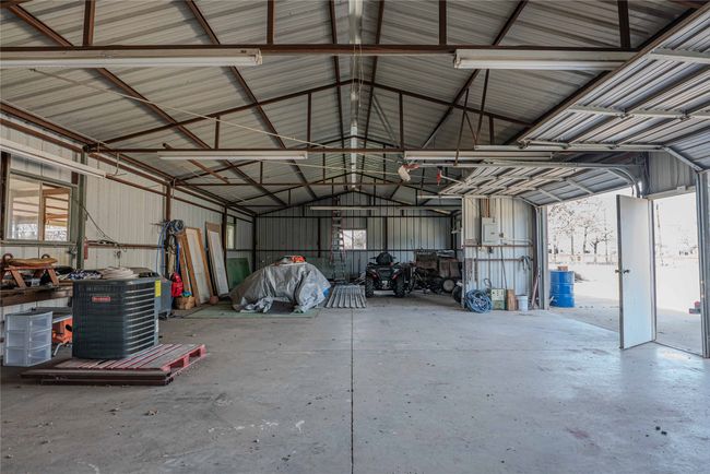 Garage featuring metal wall and electric panel | Image 28