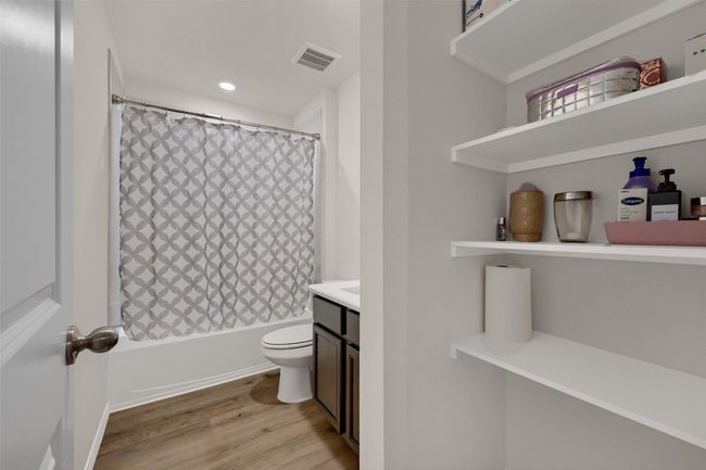 Bathroom featuring vanity, wood finished floors, shower / bath combination with curtain, and recessed lighting | Image 23