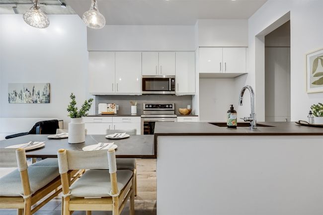 Flat-panel white cabinetry keeps the look clean and modern while offering plenty of hidden storage | Image 15
