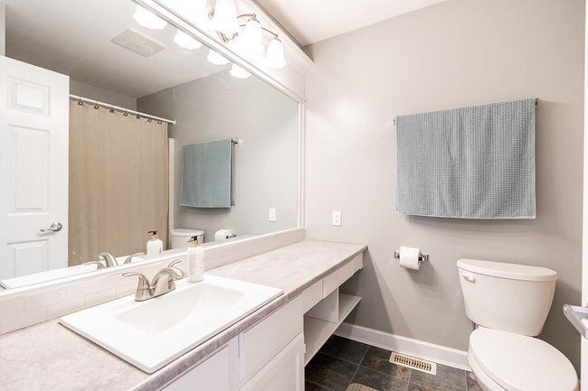 Bathroom featuring baseboards, visible vents, toilet, and vanity | Image 22