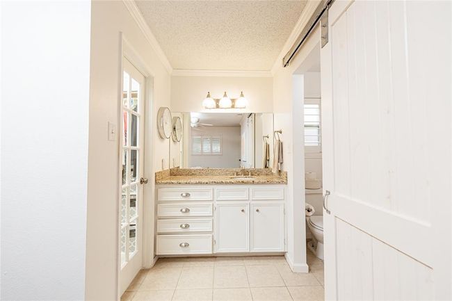 The vanity in the primary bathroom is separated from the shower area. | Image 15