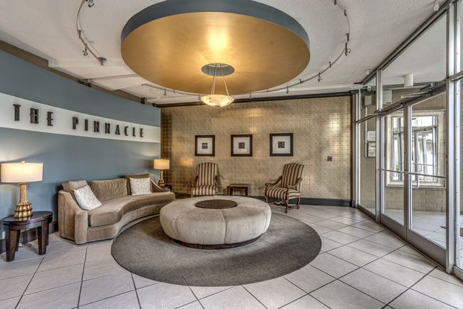 The Pinnacle welcomes both guests and residents with its modern and sophisticated lobby. Accessing the interior doors is secure and convenient, as it requires a key card for entry. Alternatively, guests can simply use the call box to reach residents. | Image 40