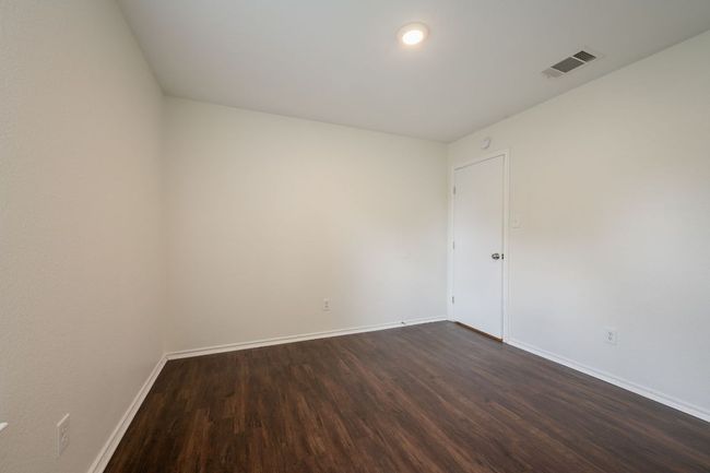 Unfurnished room with dark wood finished floors and baseboards | Image 27
