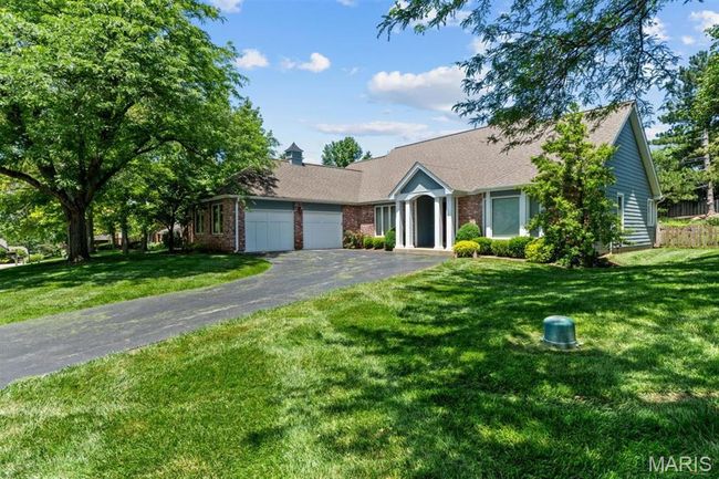 Ranch-style home with an attached garage, driveway, brick siding, a front lawn, and roof with shingles | Image 69