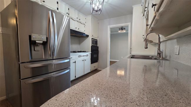 Kitchen featuring an abundance of storage and refinished counters. | Image 6