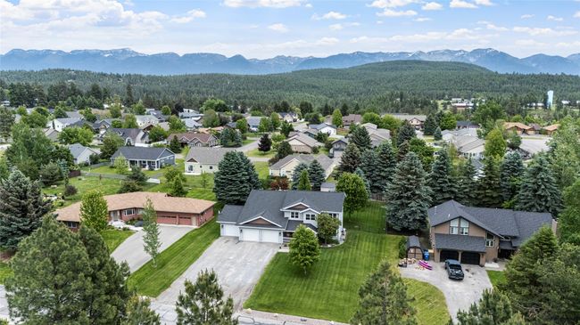 Aerial perspective of suburban area featuring a forest and mountains | Image 10