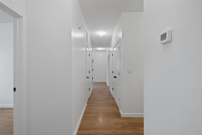 Hallway featuring wood finished floors and baseboards | Image 23