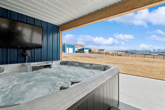 View of patio / terrace featuring a hot tub and a mountain view | Image 24