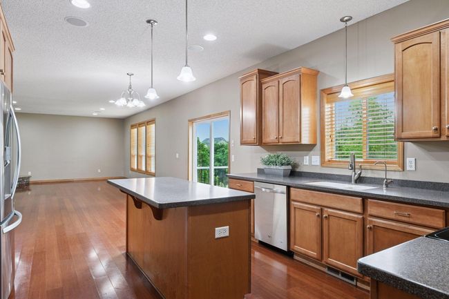 Kitchen with open floor plan just facing the living room. Large maintenance free deck off the back of the home. | Image 6
