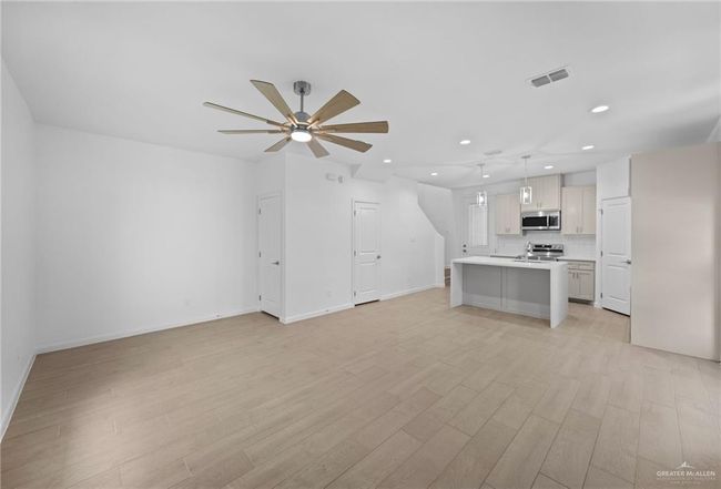 Unfurnished living room featuring recessed lighting, light wood-style floors, and a ceiling fan | Image 7