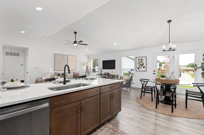 Kitchen featuring lofted ceiling, sink, decorative light fixtures, dishwasher, and light wood-type flooring | Image 18