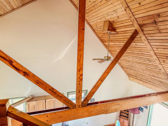 Room details featuring a ceiling fan, beamed ceiling, and wood ceiling | Image 15