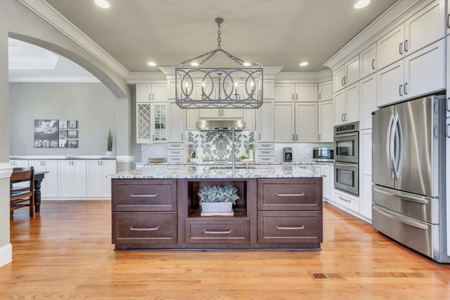 Oversized island with granite counters and large drawer storage. The refrigerator remains with the home. | Image 15