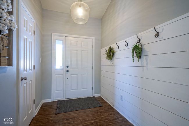 entryway with dark wood-style floors and baseboards | Image 5