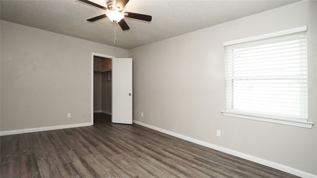 The primary bedroom features a nice window for natural light. Note that all of the windows in the home have been replaced with low-e windows | Image 13