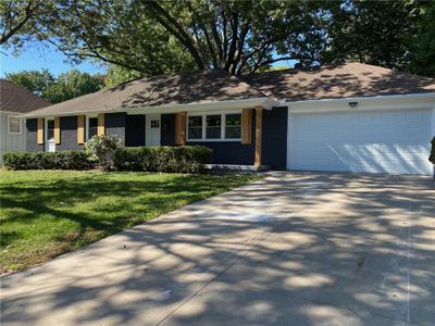 Ranch-style home featuring a garage and a front lawn | Image 2