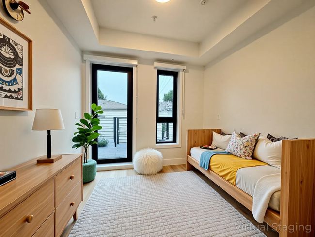 Bedroom with light wood-type flooring, a tray ceiling, and access to outside | Image 26