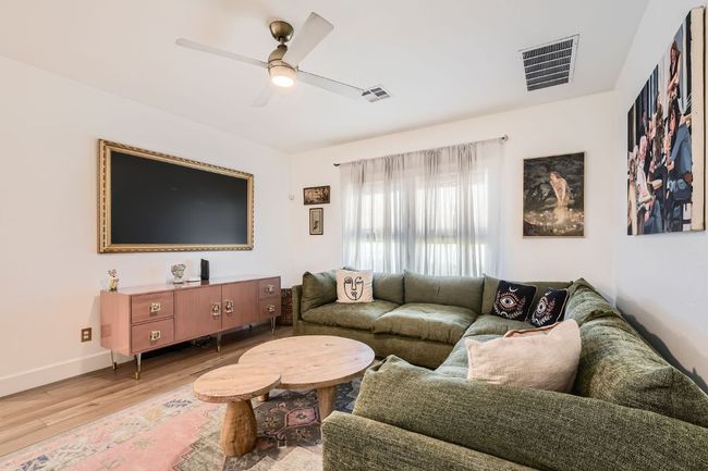 Living area featuring wood finished floors and ceiling fan | Image 9