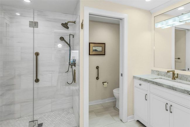 Full bathroom featuring toilet, a stall shower, vanity, and recessed lighting | Image 14