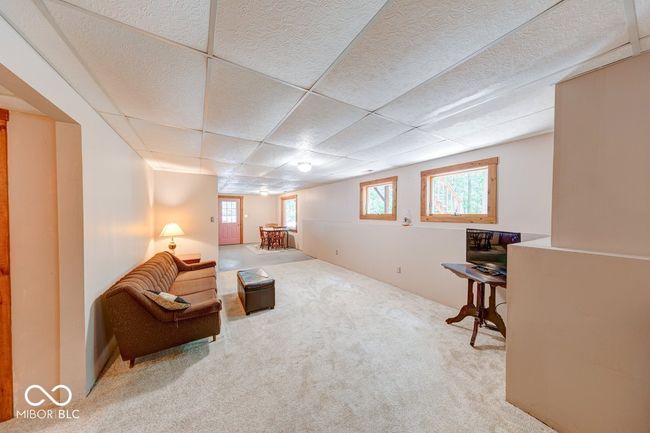 sitting room with carpet floors and a paneled ceiling | Image 18