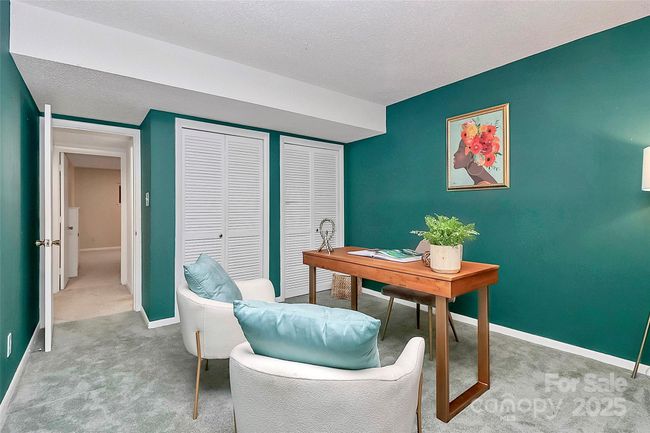 Perfect office or additional bedroom offers access to the lower patio and views of the lake. | Image 16