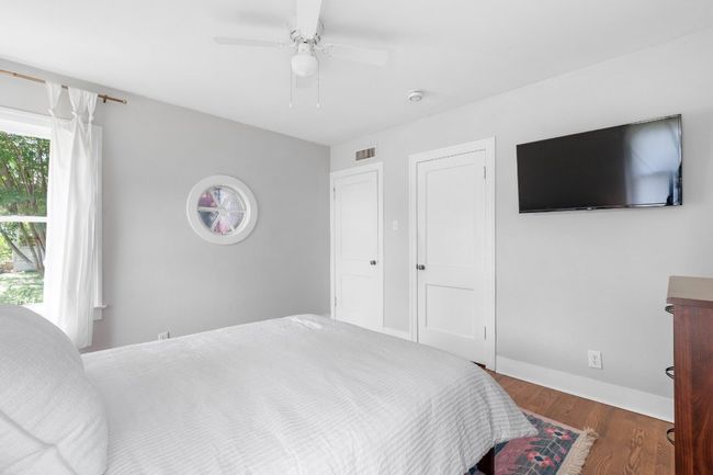 Unique circular window is a highlight of the primary bedroom | Image 21