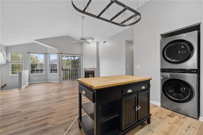 kitchen island with large living room with vaulted ceilings | Image 12