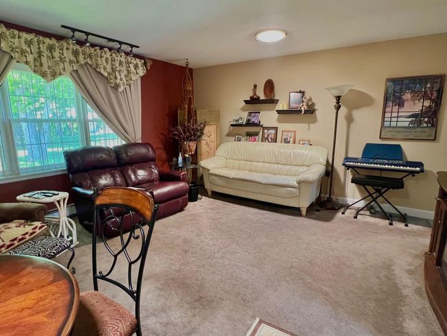 Carpeted living room with baseboards | Image 10