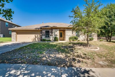 View of front of house with cooling unit, a garage, and a front lawn | Image 2