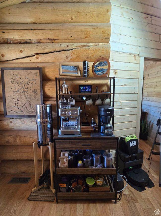 Interior details featuring rustic walls, visible vents, and wood finished floors | Image 62