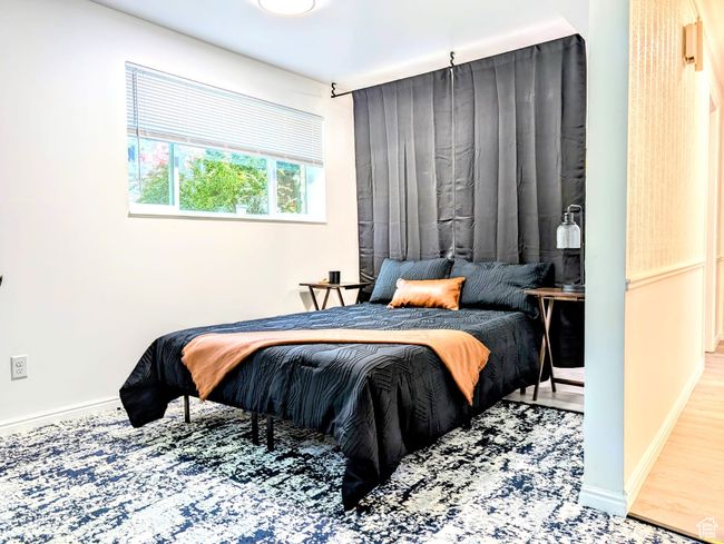 Bedroom with baseboards and wood finished floors | Image 8