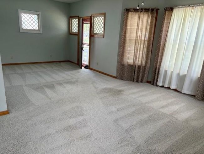 Carpeted Living room featuring baseboards | Image 12