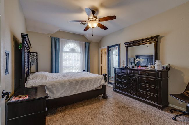 Carpeted bedroom with lofted ceiling and a ceiling fan | Image 30