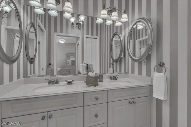Full bathroom with wallpapered walls and double vanity | Image 18