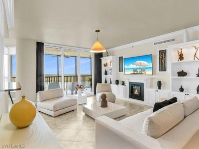 Living room with built in features, ornamental molding, and light tile floors | Image 2