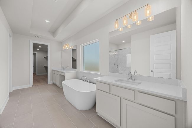 Bathroom featuring a marble finish shower, two vanities, a freestanding bath, recessed lighting, and baseboards | Image 16
