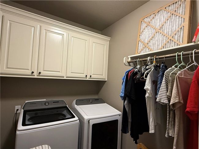 Washroom with separate washer and dryer and cabinet space | Image 19