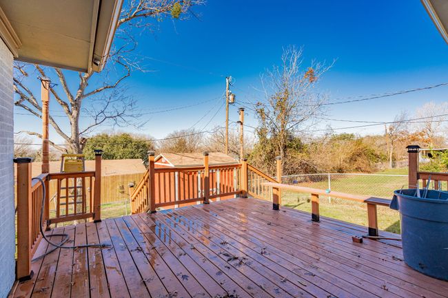 Wooden deck with a fenced backyard | Image 23