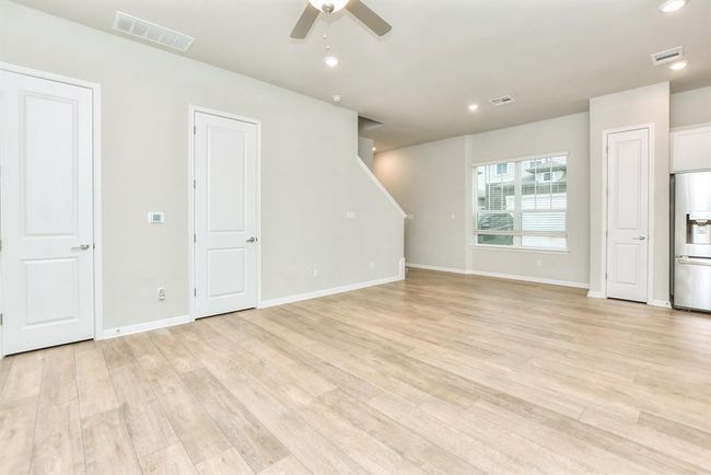 Unfurnished room featuring a ceiling fan, stairway, light wood-style flooring, and recessed lighting | Image 11