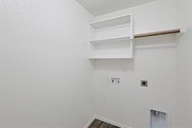Laundry room with electric dryer hookup, hookup for a washing machine, gas dryer hookup, and wood finished floors | Image 16
