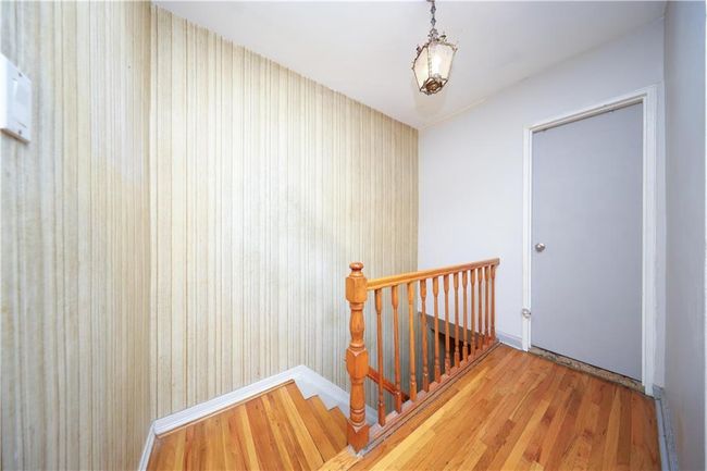 Hallway featuring wood finished floors and an upstairs landing | Image 13