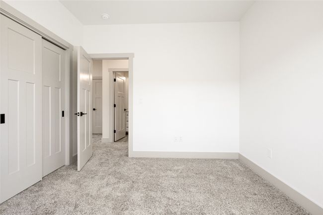 Unfurnished bedroom with light colored carpet and a closet | Image 26
